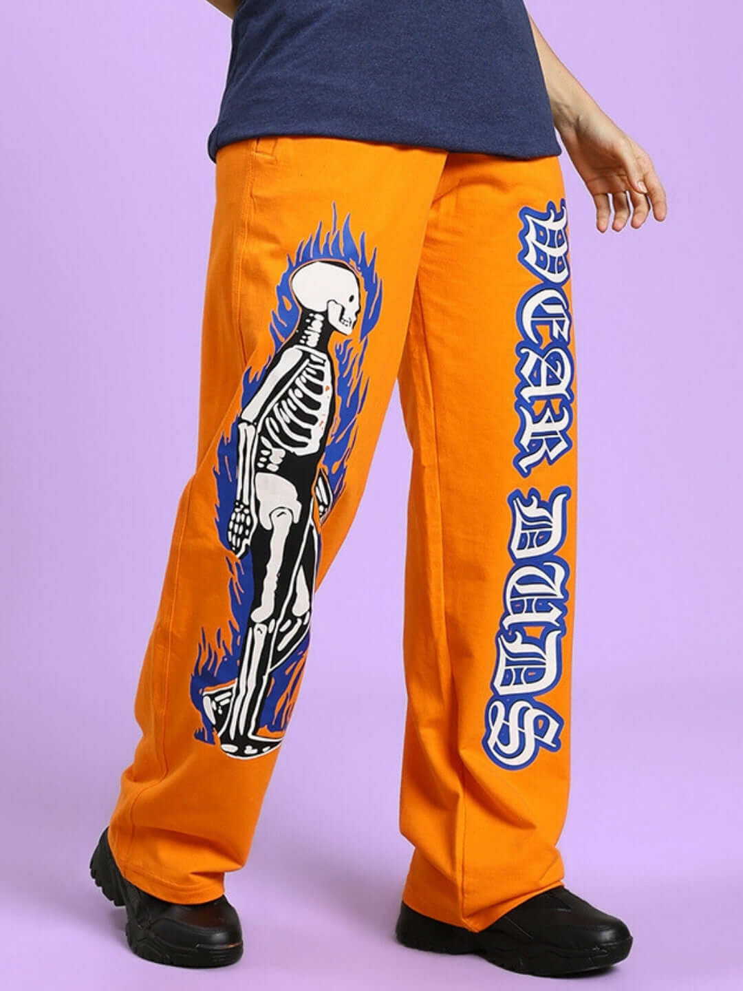 Orange relaxed fit jogger featuring a flaming skeleton print, perfect for stylish comfort. Ideal for custom fit options at DUDS.