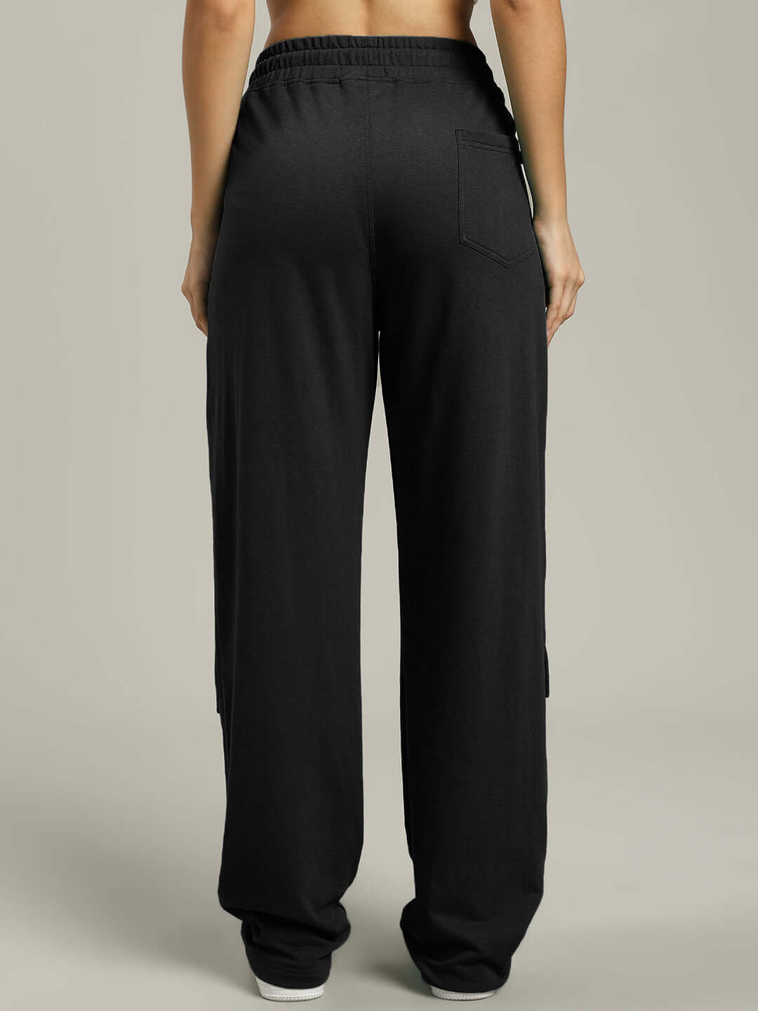 Back view of women's black flap pocket baggy jogger pants, showcasing custom fit options and quality tailoring.