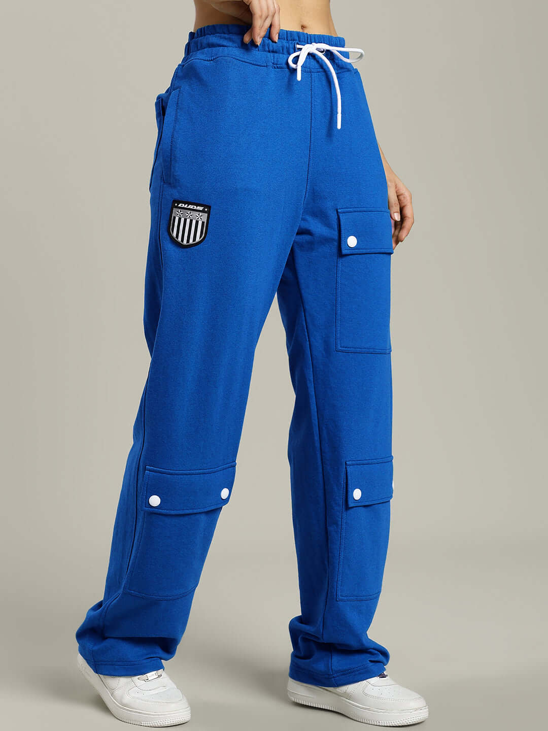 Blue women's baggy jogger with flap pockets and drawstring, designed by DUDS, offering customizable fit options.