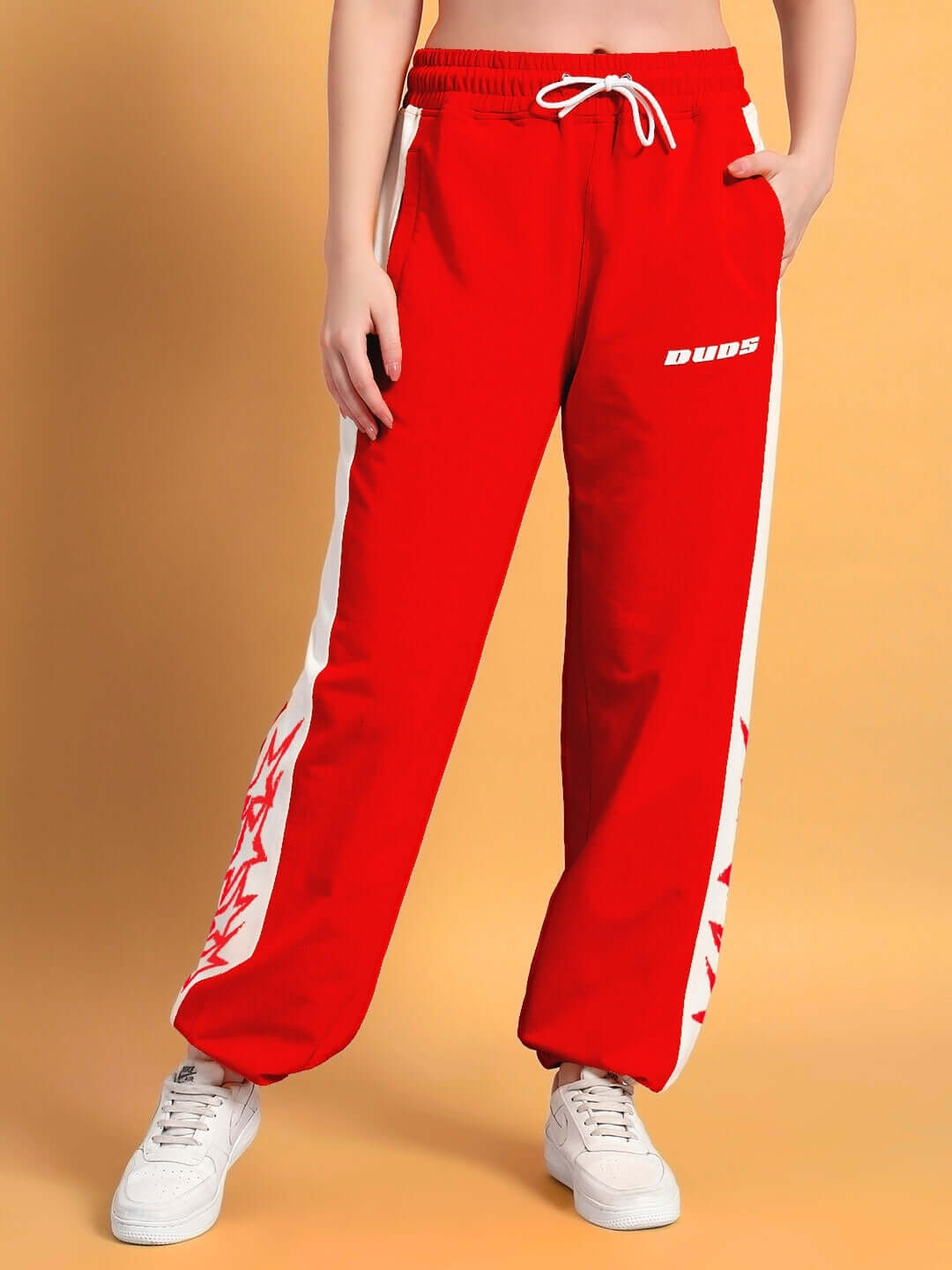 Women's flash relaxed fit joggers in red with white accents by DUDS, featuring a comfortable design with custom sizing options.