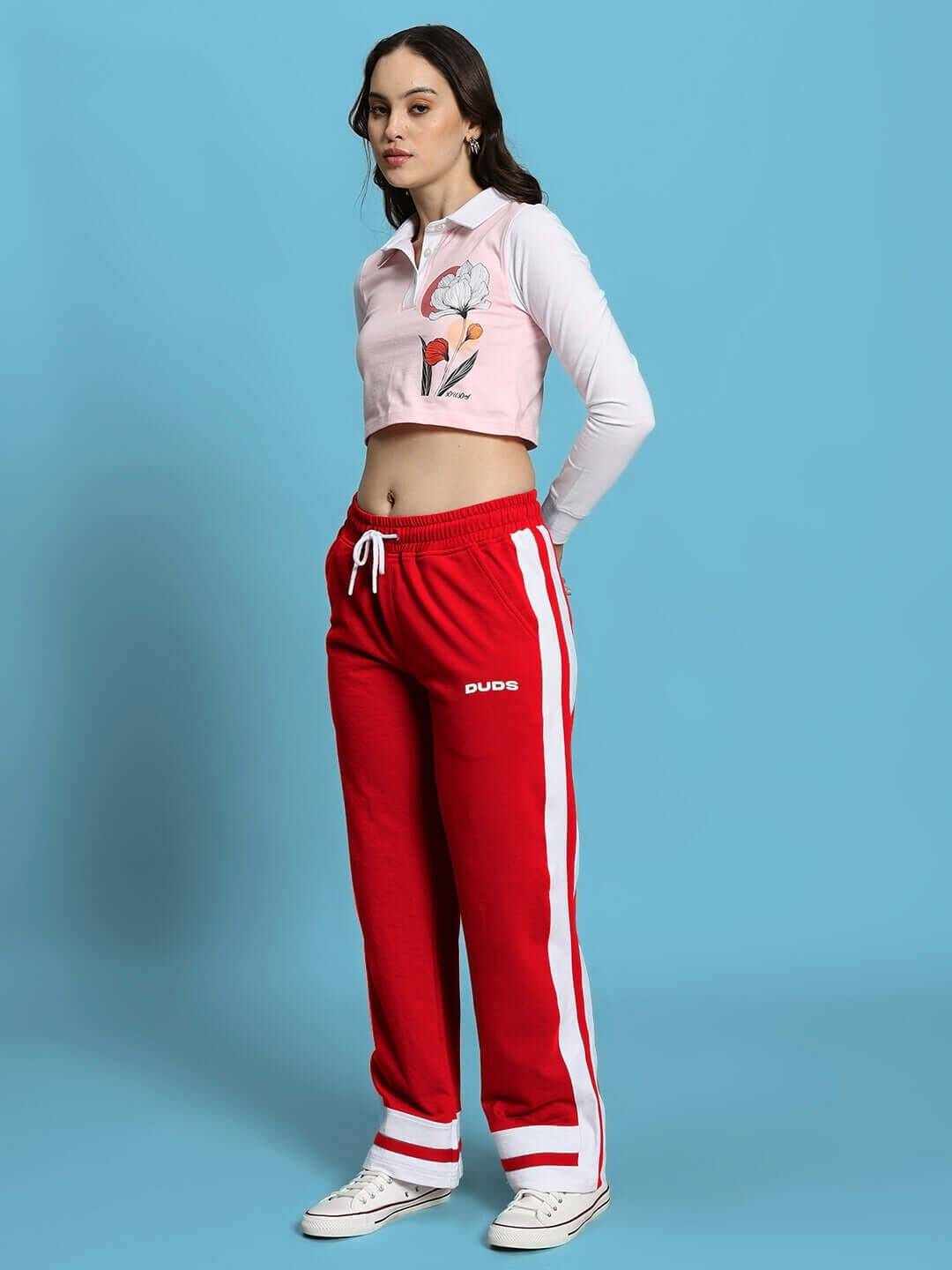 Model wearing WOMEN'S FLORA CO-ORD SET PINK RED from WEAR DUDS, featuring a pink top and red pants in a chic streetwear style.