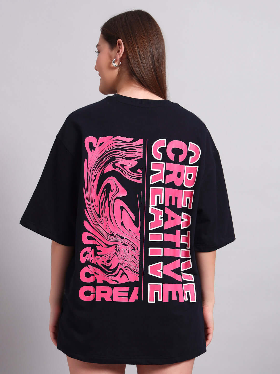 Back view of women's navy blue oversized t-shirt with creative pink print, premium cotton fabric, country of origin India