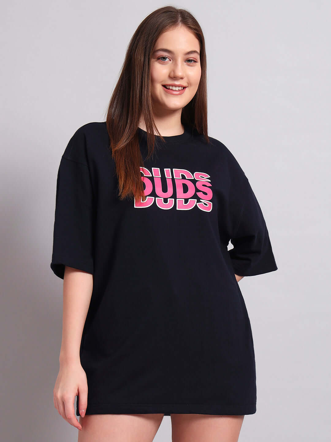 Model wearing women's navy blue oversized T-shirt with creative print, made from premium cotton fabric, designed by Color By Colours.