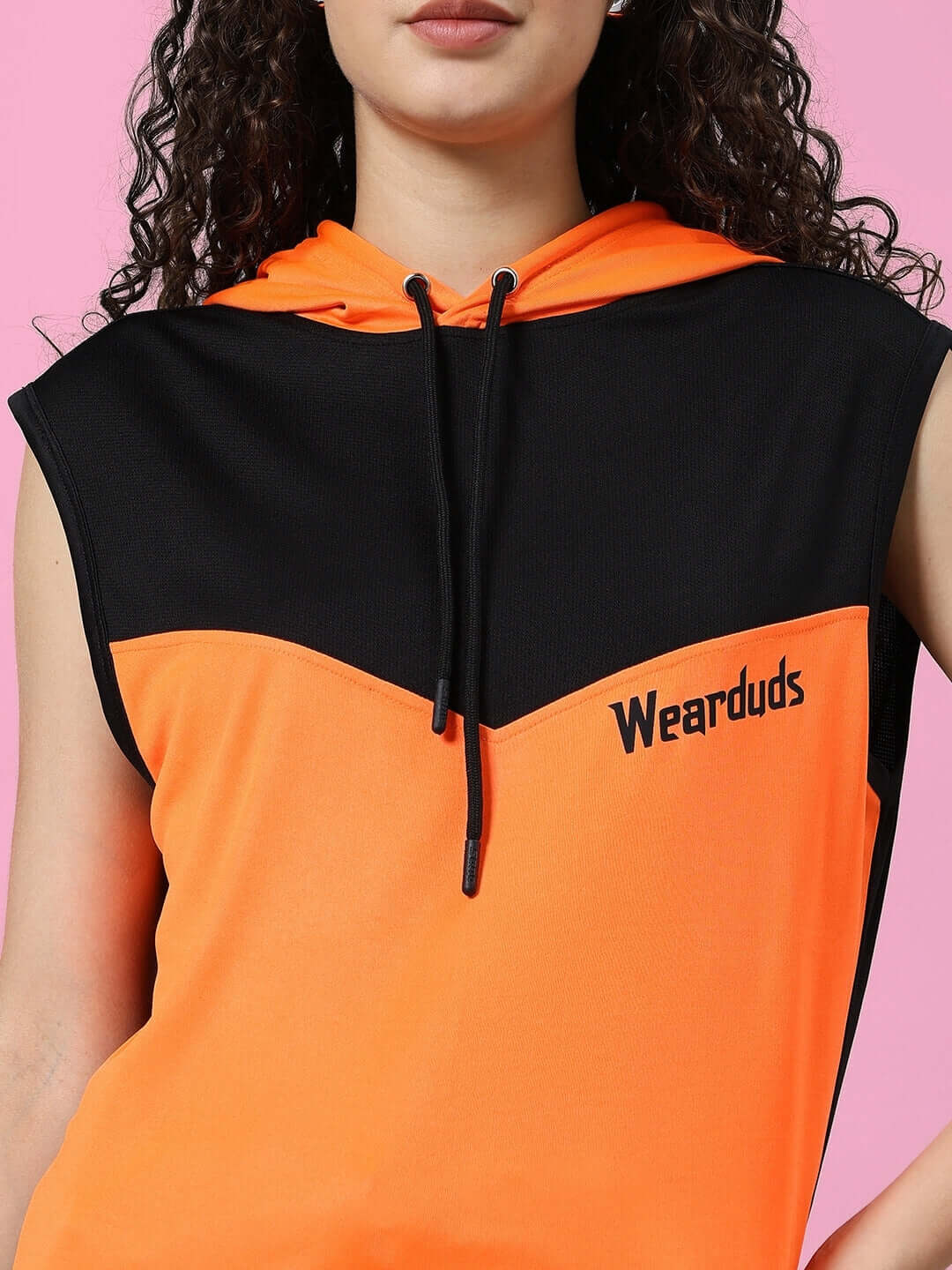 Woman wearing WOMEN'S FRANKY GYM CO-ORD SET ORANGE BLACK with hood. Sports polyester fabric, ideal for workouts.