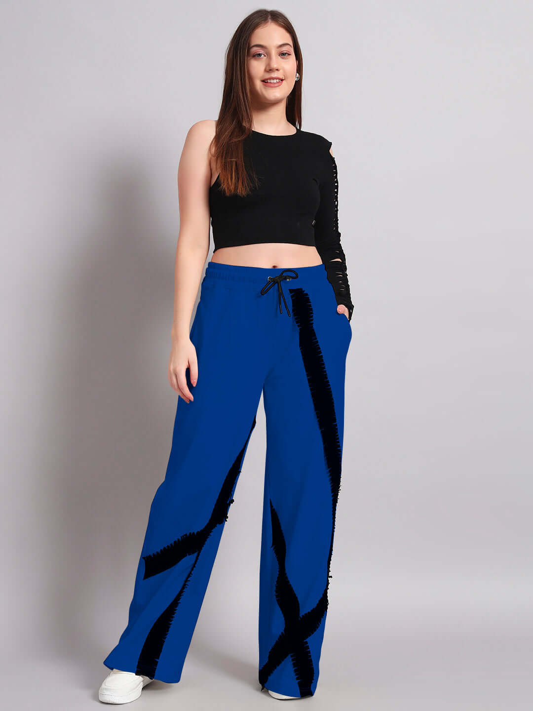 Woman wearing black and blue frayed textured stripes co-ord set with elasticated joggers, showcasing relaxed fit fashion.