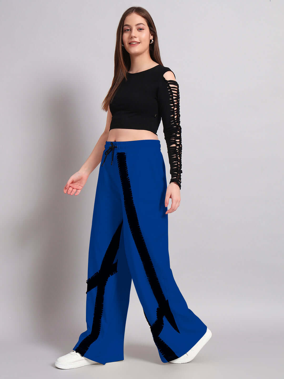 Woman wearing black and blue frayed co-ord set with textured stripes, featuring relaxed fit joggers and a black top, fashion outfit display.