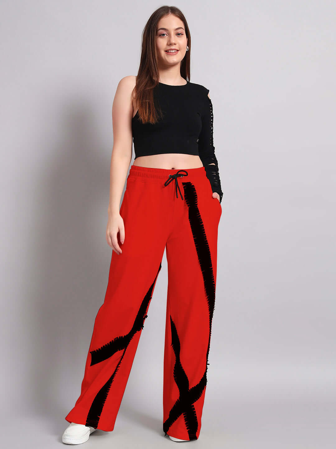 Woman wearing black and red frayed textured stripes co-ord set; relaxed joggers with elasticated waistband for comfort.