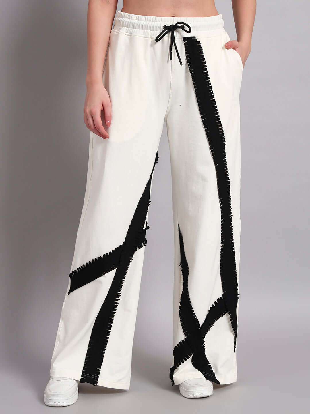 Women's frayed textured stripes jogger in off white with black accents, displayed on a model standing against a neutral background.
