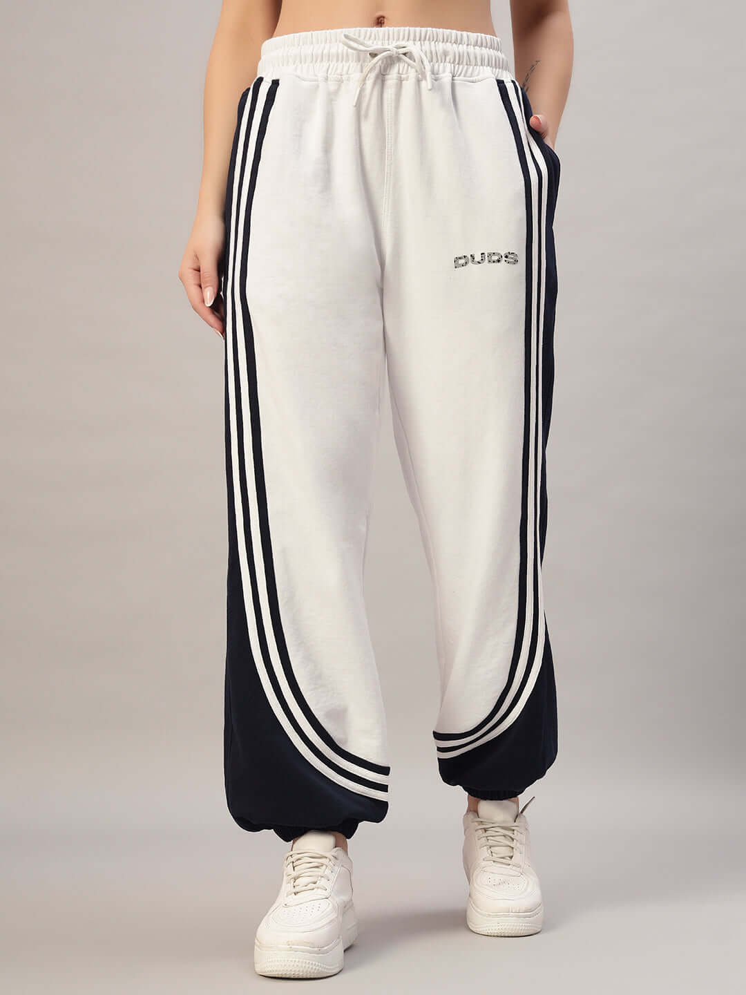 Woman wearing DUDS Women's Frenzy Curve Contrast Joggers in white and navy, showcasing tailored fit and custom size options.