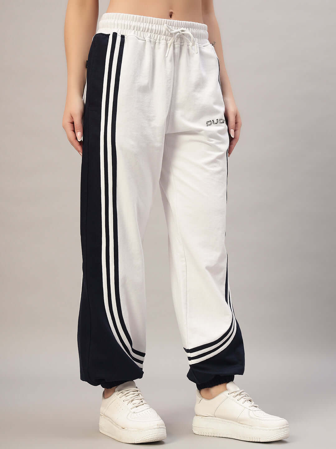 Women's white and navy contrast joggers by DUDS, featuring customizable size options, made-to-order for perfect fit, athletic style.