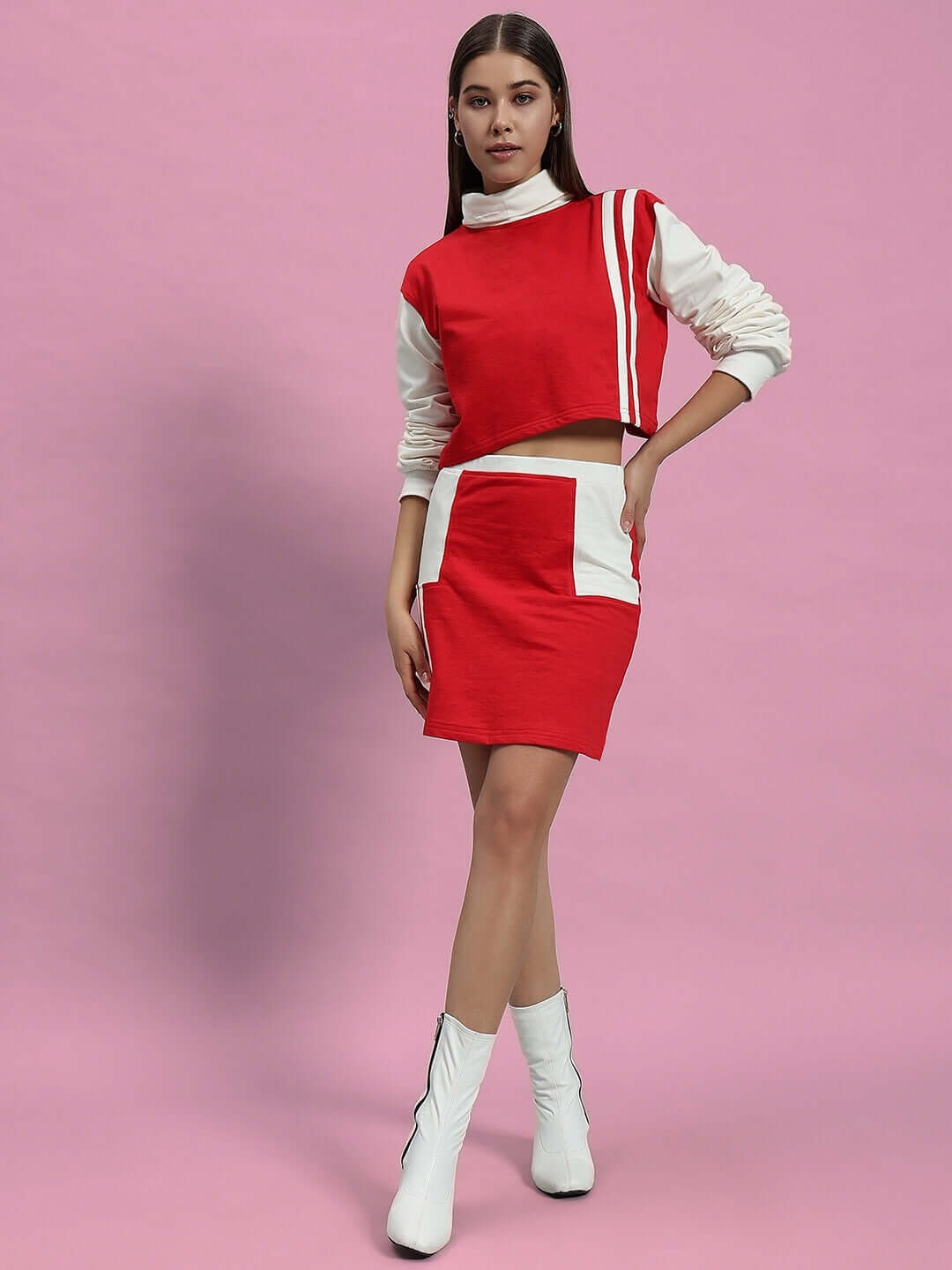 Model wearing Women's Freya Co-Ord Set in off white and red, made from premium cotton blend terry fabric, on a pink background.