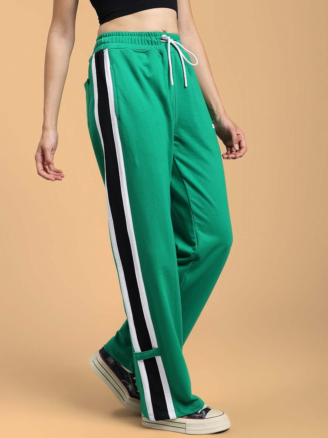 Green Women's Rosston Flat-Out Relaxed Fit Joggers with white and black side stripes, designed by DUDS, shown on a standing model.