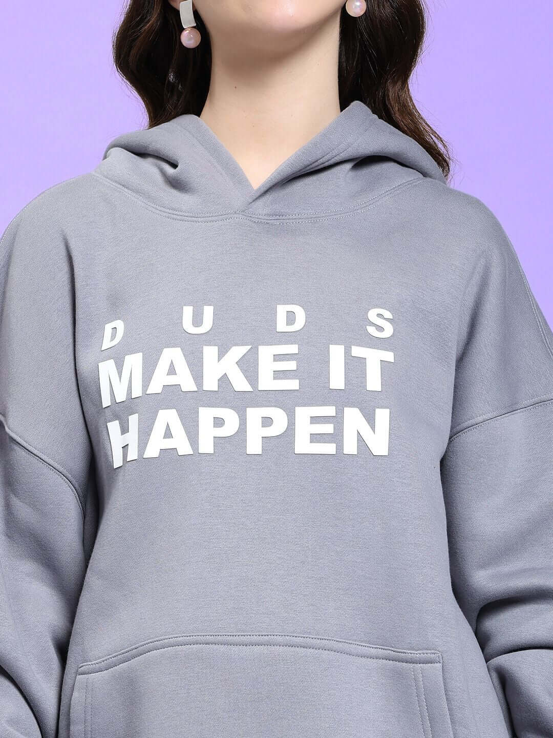 Close-up of WOMEN'S MAKE IT HAPPEN FLEECE HOODIE GREY with "Make It Happen" text on front, highlighting stylish design.