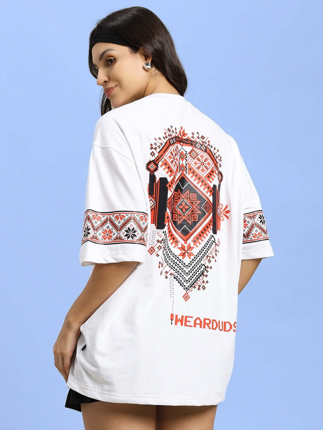 Woman wearing white vyshyvanka print T-shirt featuring headphones design, made of premium cotton fabric. Origin: India.