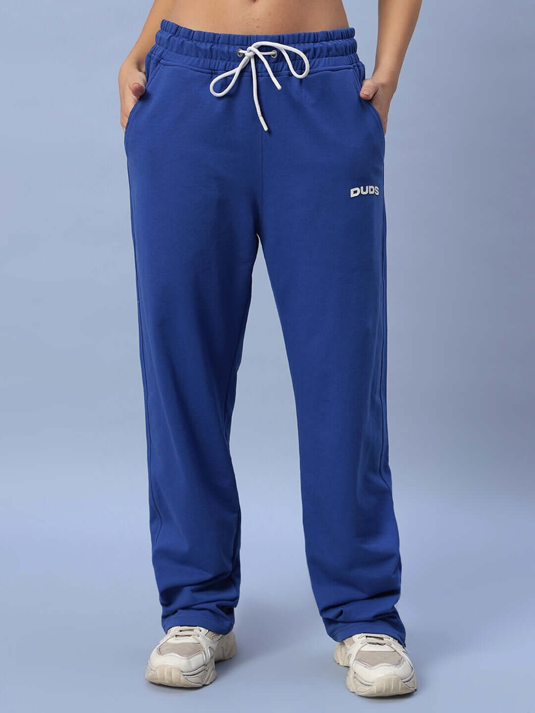 Model wearing women's royal blue Hershey side slit joggers by DUDS, featuring a comfortable fit and side pockets.