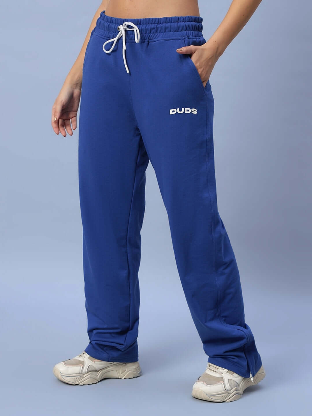 Royal blue women's Hershey side slit joggers by DUDS with custom fit option, displayed with white sneakers.