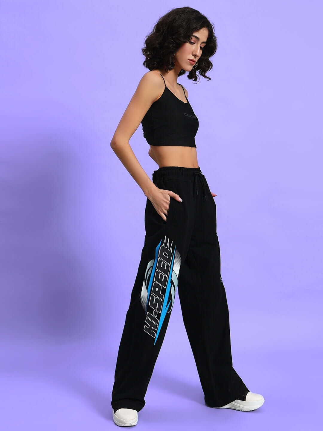 Model wearing Women's Hi-Speed Relaxed Fit Jogger in black with a stylish design on the leg.