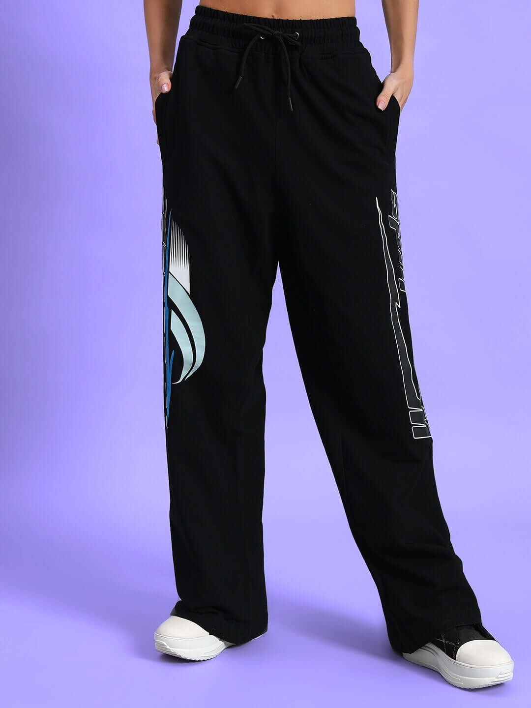 Black women's relaxed fit jogger pants with side pockets and design print, perfect for casual wear.