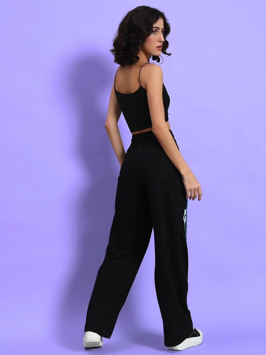 Model wearing black women's hi-speed relaxed fit jogger, showcasing comfortable and stylish design from DUDS, side view.