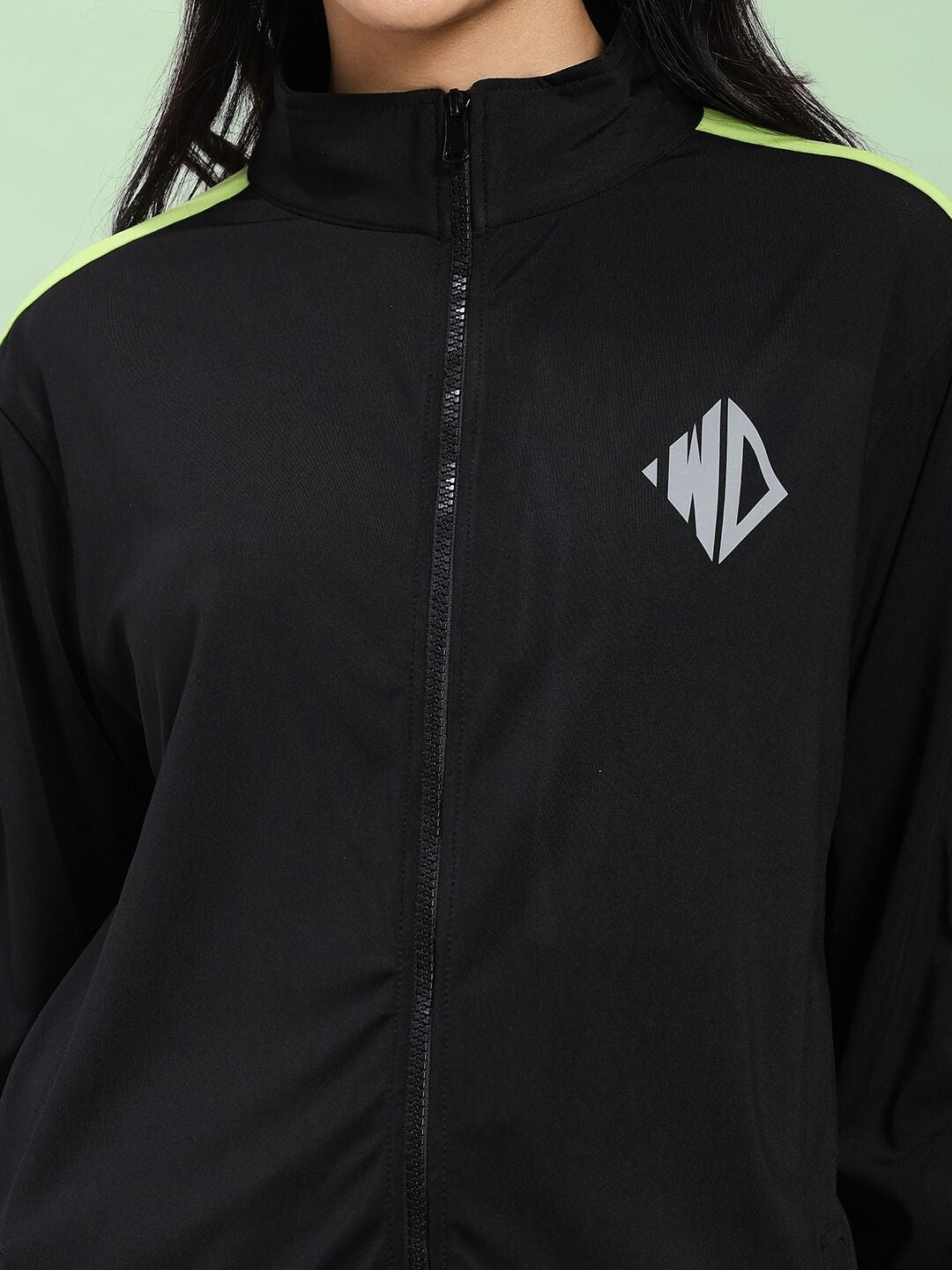 Close-up of WOMEN HIGH PERFORMANCE JACKET IN BLACK with sleek design and logo detailing.
