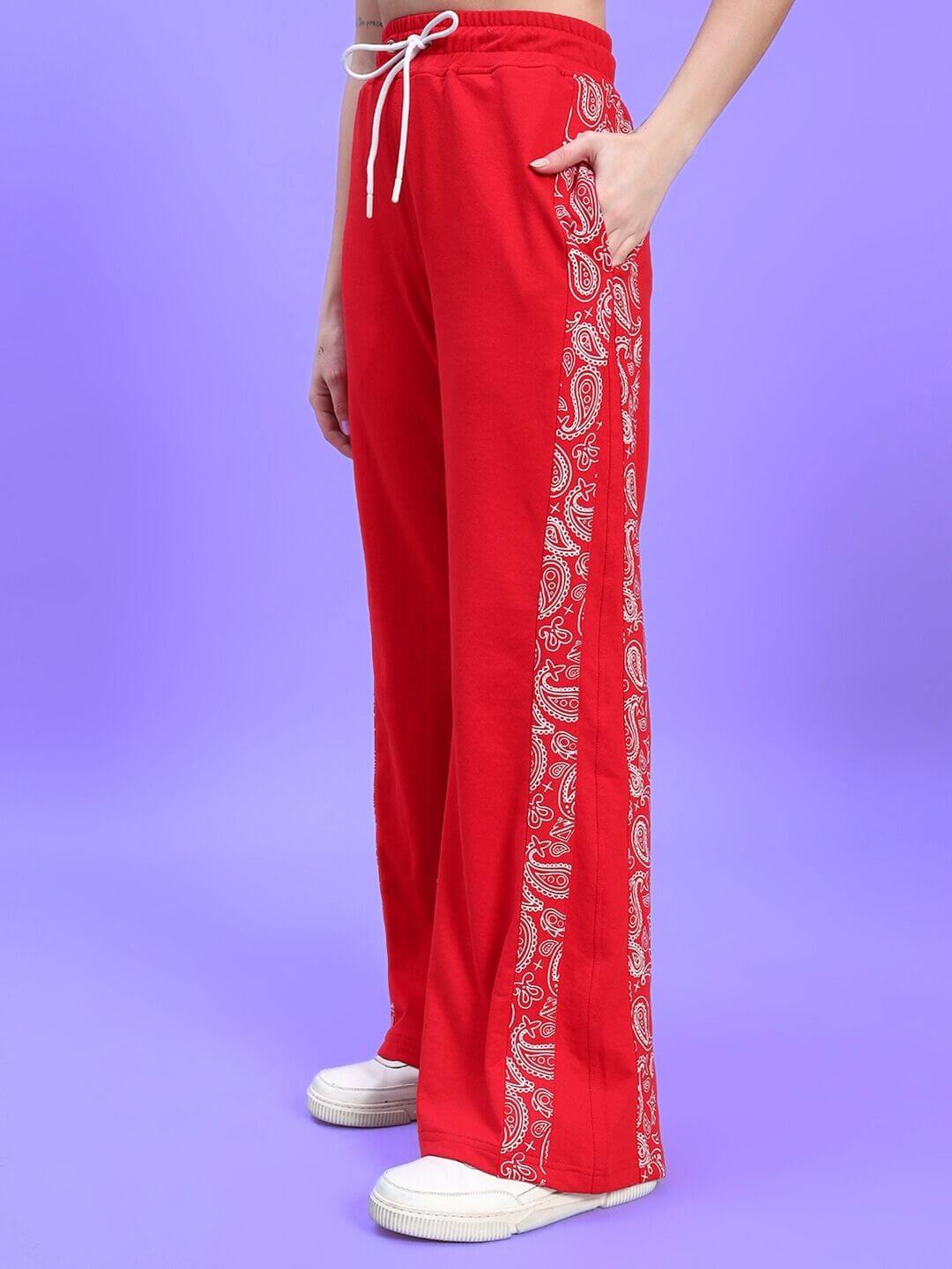 Model wearing vibrant red WOMEN'S HOLLY CO-ORD SET - RED with paisley side detailing and drawstring waistband, showcasing trendy style and comfort.