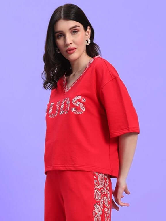 Woman wearing WOMEN'S HOLLY RELAXED FIT TOP RED by WEAR DUDS, styled in modern streetwear with vibrant red color.