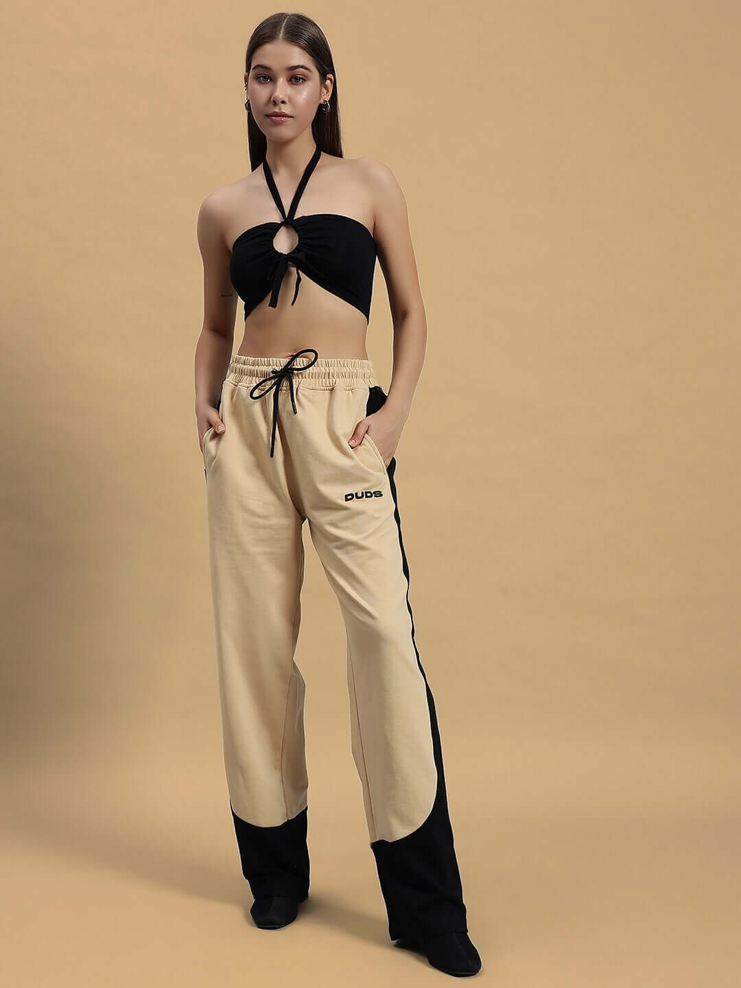 Model wearing DUDS beige-black Women's Hurtle Baggy Joggers, showcasing relaxed fit and stylish design.