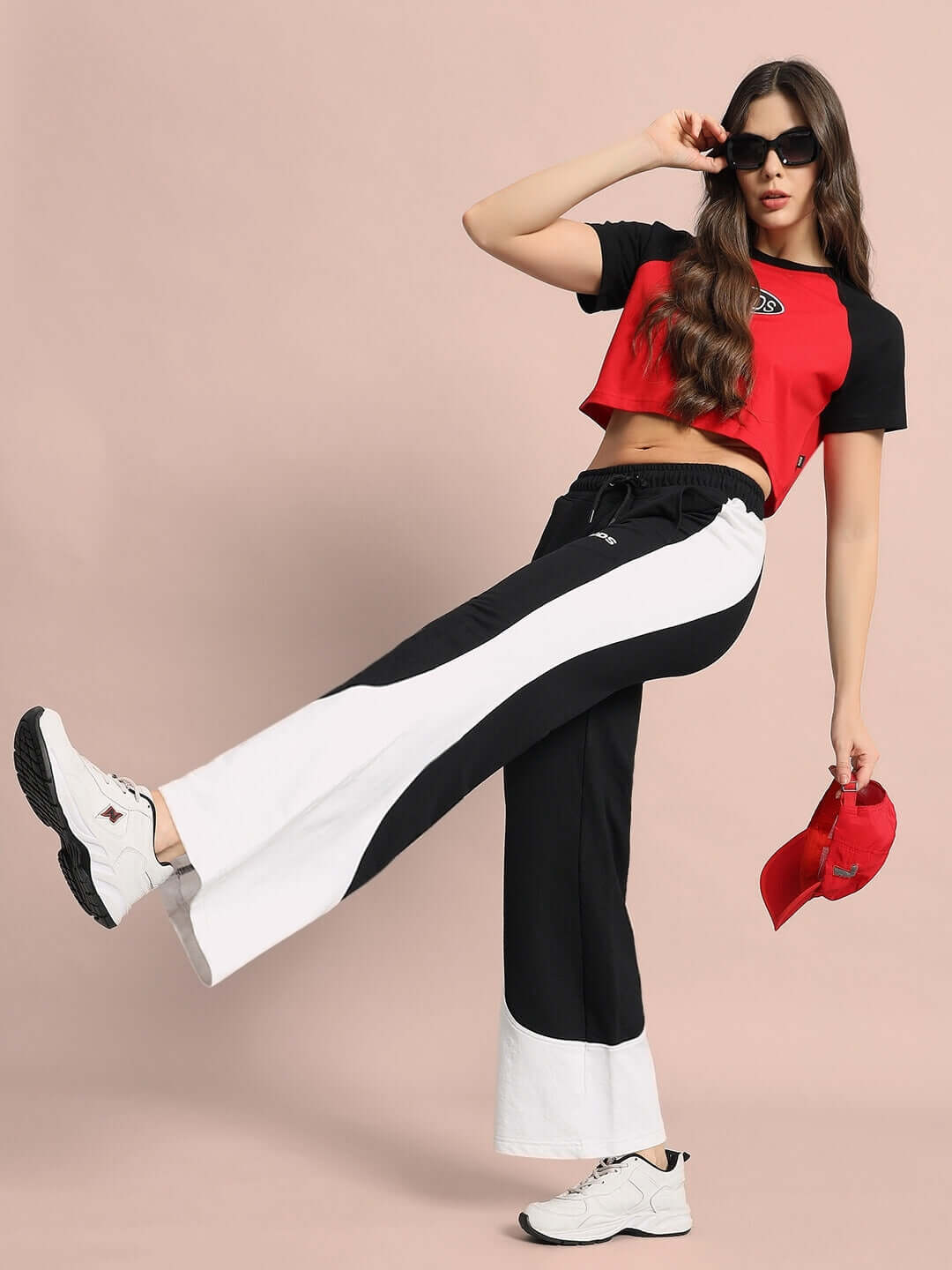 Model wearing women's Hurtle baggy joggers in black-white with a red top, showcasing trendy athletic fashion.