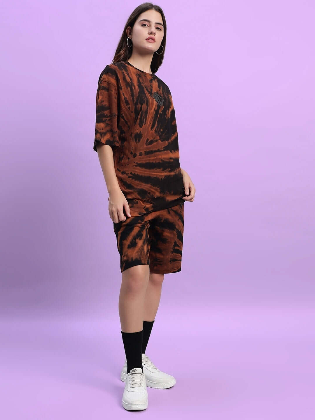 Model wearing Women's Hustler Tie-Dye Co-ord Set in black, featuring premium cotton fabric and stylish design on a purple background.