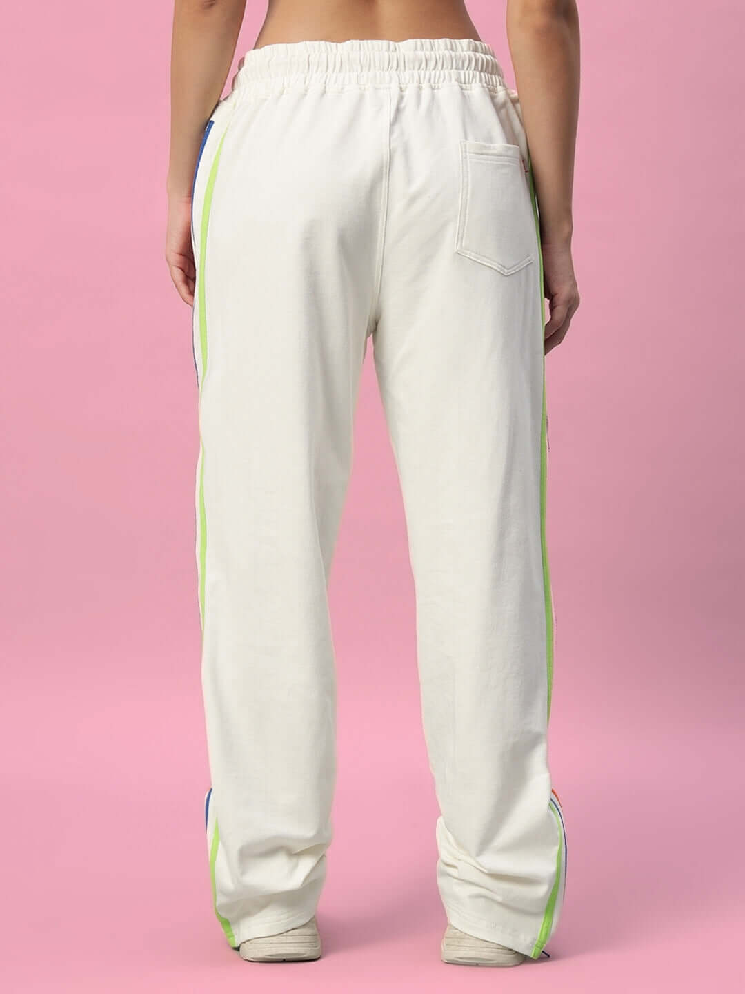 Back view of women's off-white joggers with side zippers and colorful stripe, designed by DUDS Tailors.