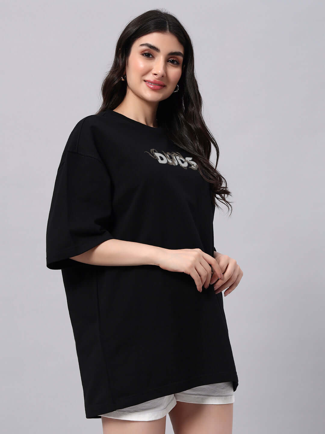 Women wearing Jelvin oversized black T-shirt made of premium cotton with slogan print, showcasing casual and stylish fashion.