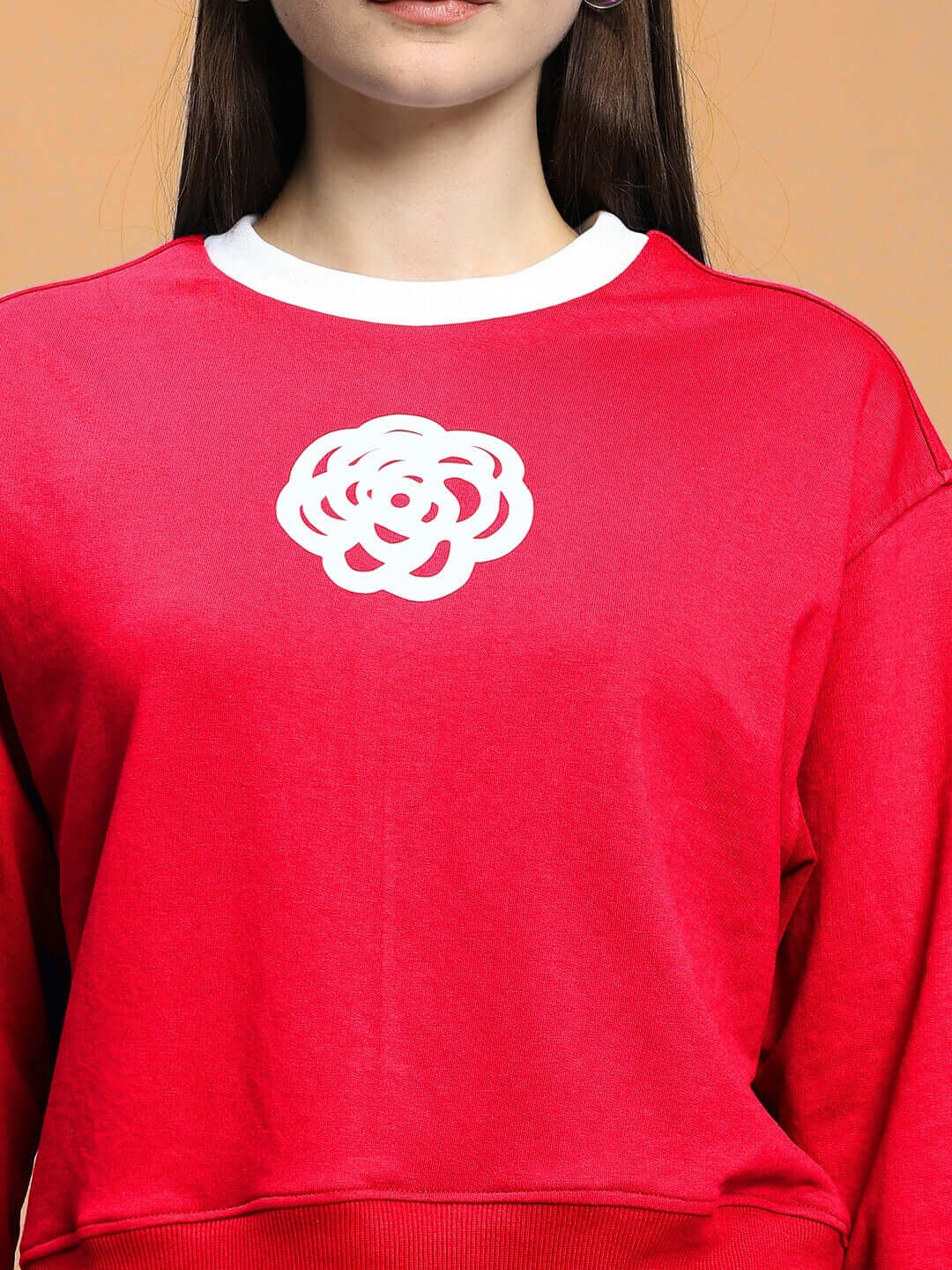 Model wearing WOMEN'S JESSFLICK RELAXED FIT CO-ORD SET RED, featuring a white floral design on red cotton-blend fabric.