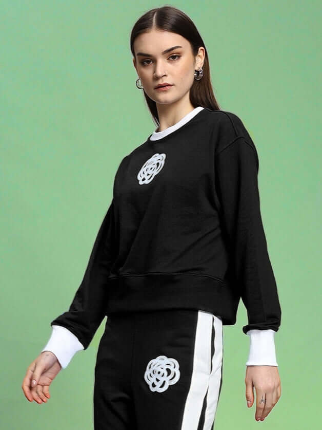 Woman wearing Jessflick relaxed fit black sweatshirt with white accents, crafted from premium cotton French terry lycra.