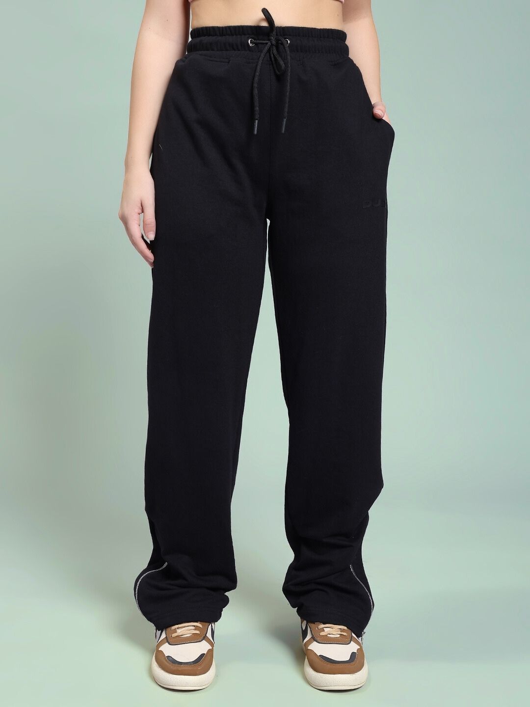 Woman wearing WOMEN'S JOSS WINS RELAXED-FIT JOGGER BLACK with sneakers, showcasing a casual style.