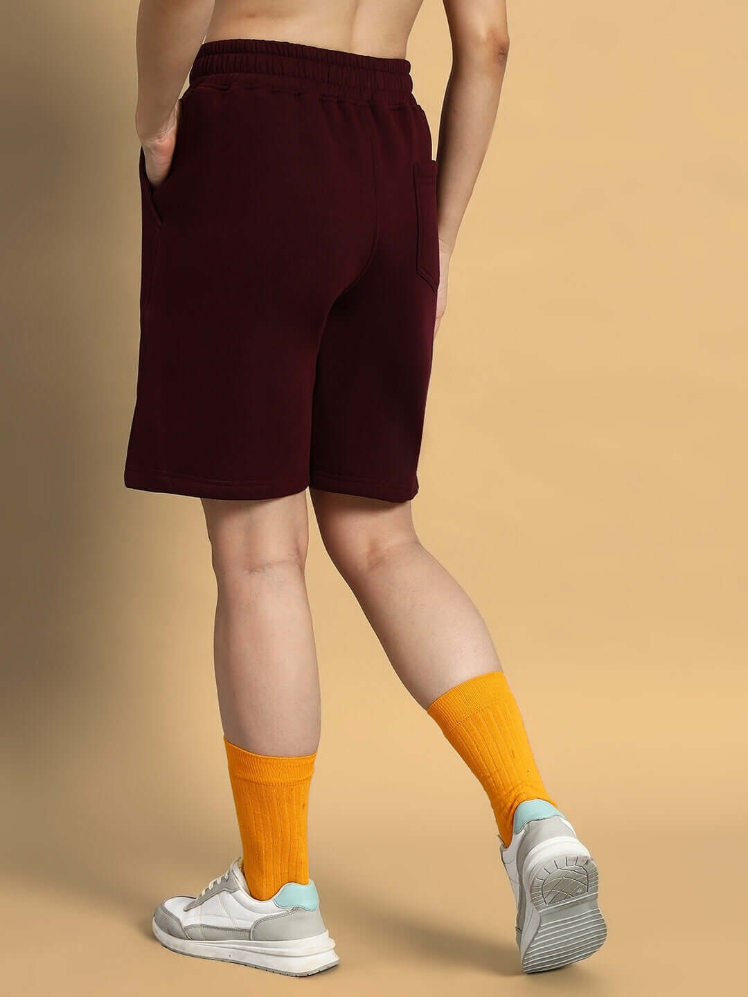 Back view of person wearing Women Jumbled Fleece Shorts Wine by WEAR DUDS with orange socks and sneakers.