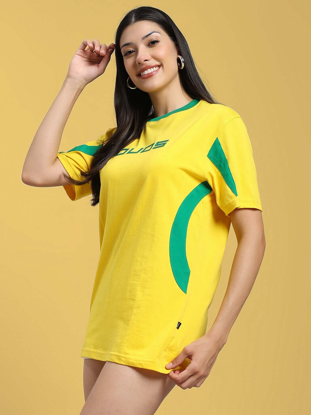 Woman wearing a yellow-green regular fit t-shirt made from 100% cotton, featuring a stylish design, ideal for casual wear.