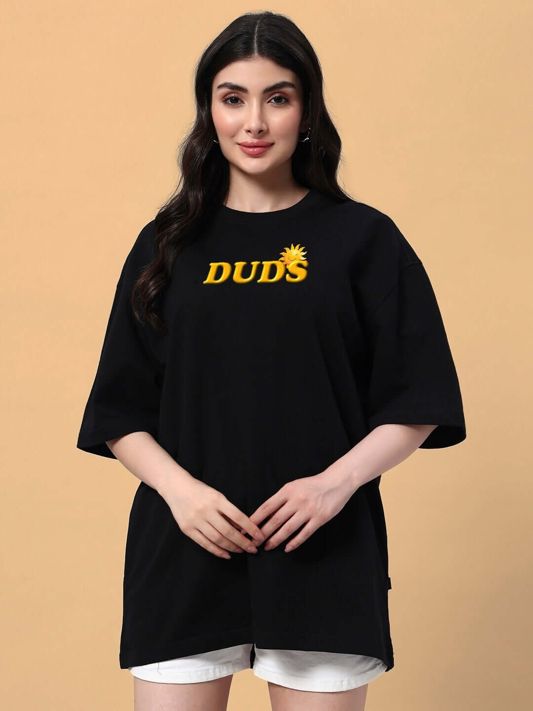 Woman wearing a black oversized Labubu Monsters t-shirt with yellow 'DUDS' text, perfect for a stylish and comfortable summer look.