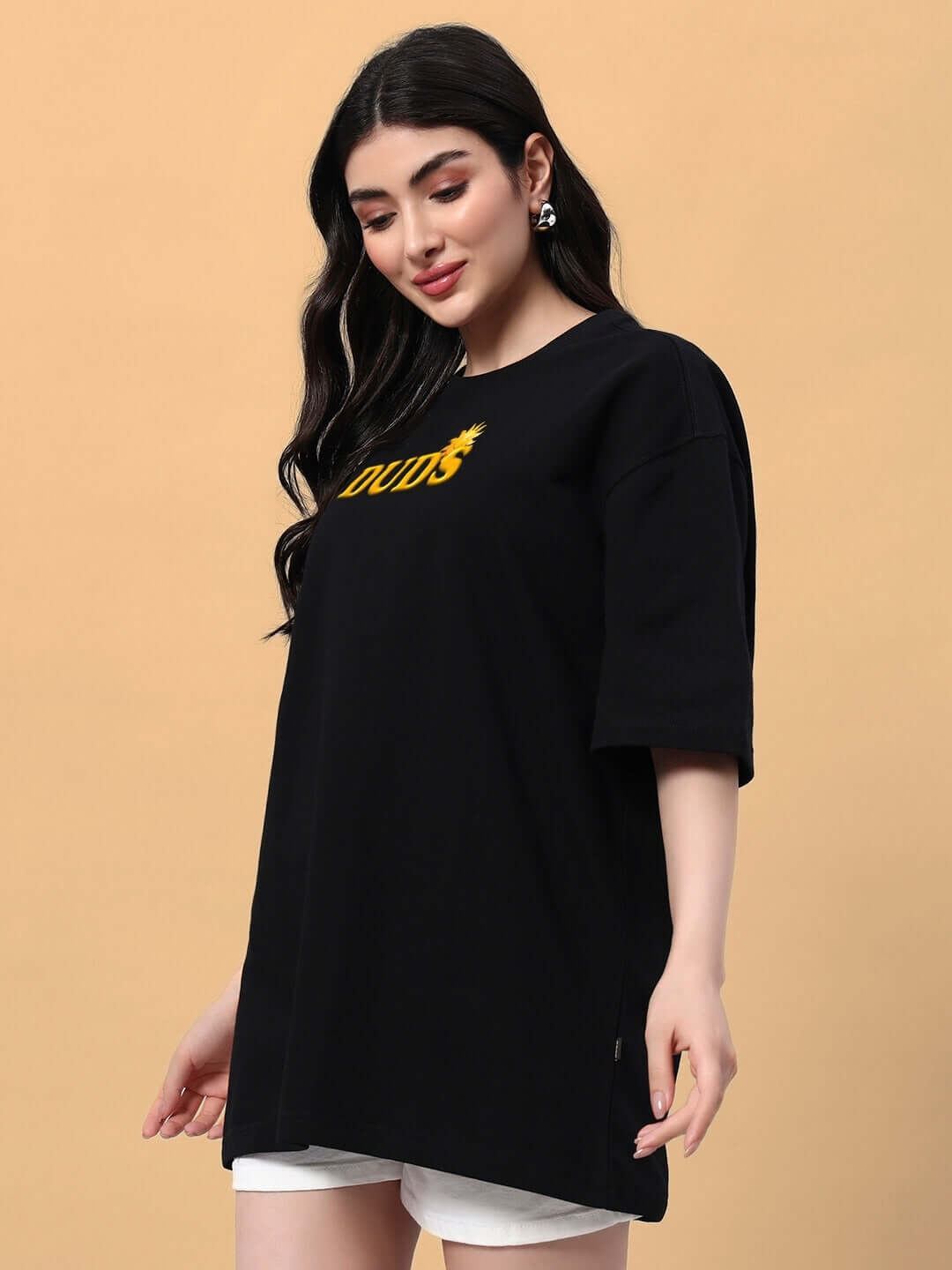 Woman wearing black oversized Labubu Monsters t-shirt, styled with white shorts, showcasing trendy summer fashion.