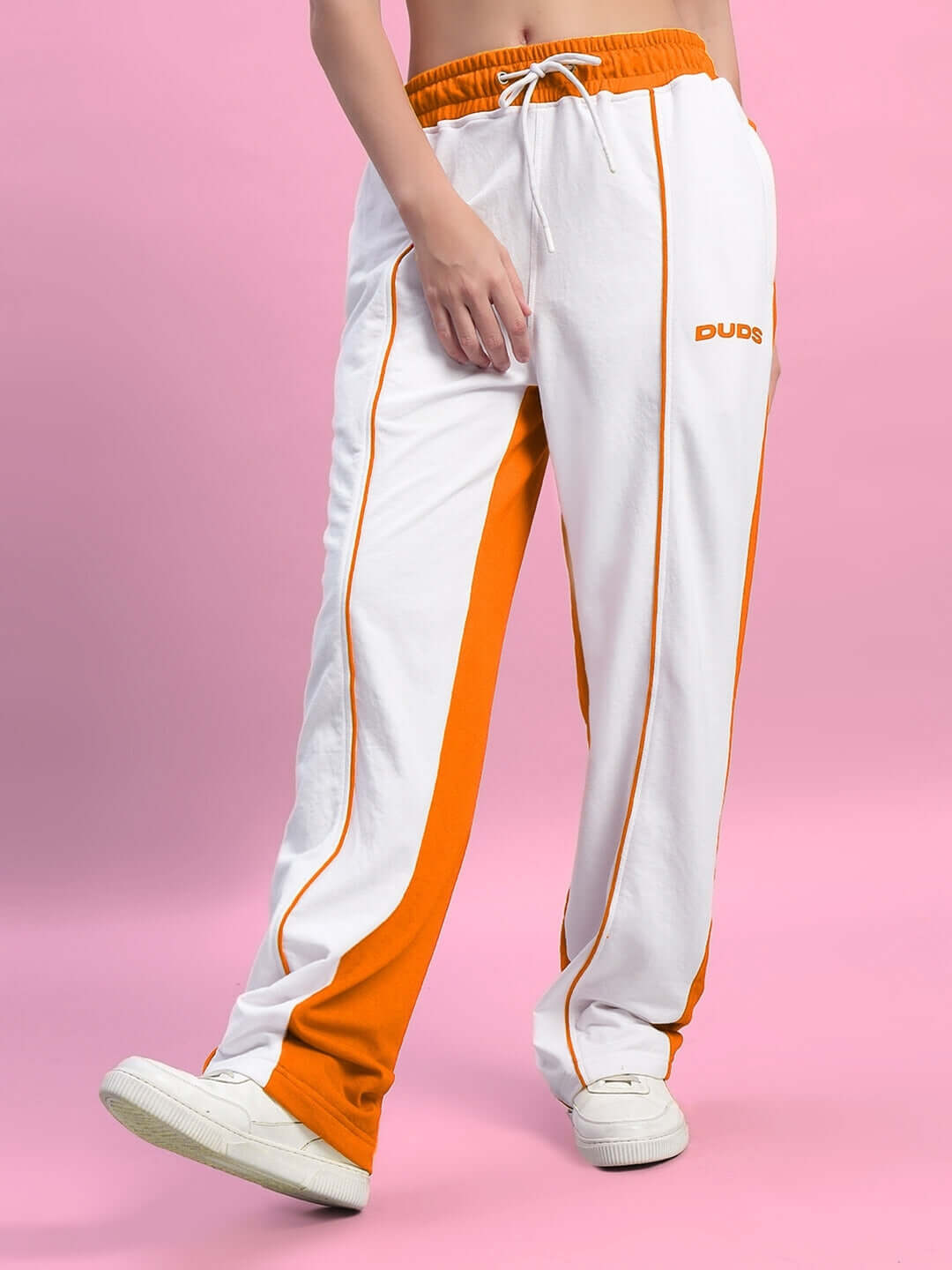 Women's Lagoon Relaxed Fit Joggers in white and orange, featuring custom fit option, shown on pink background.