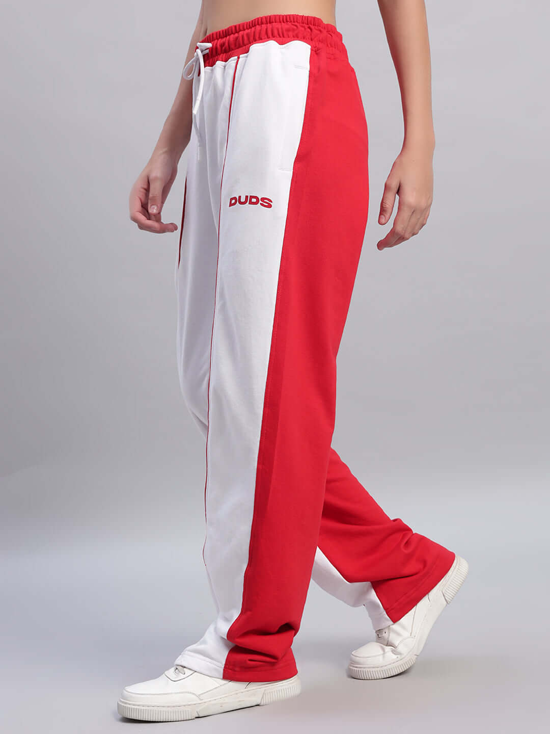 Women's Lagoon Relaxed Fit Joggers in white and red, displayed from the side, worn by a model with white sneakers.