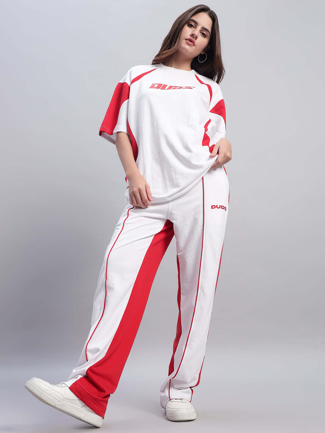 Model wearing Women's Lagoon Relaxed Fit Joggers in white and red with customizable options.