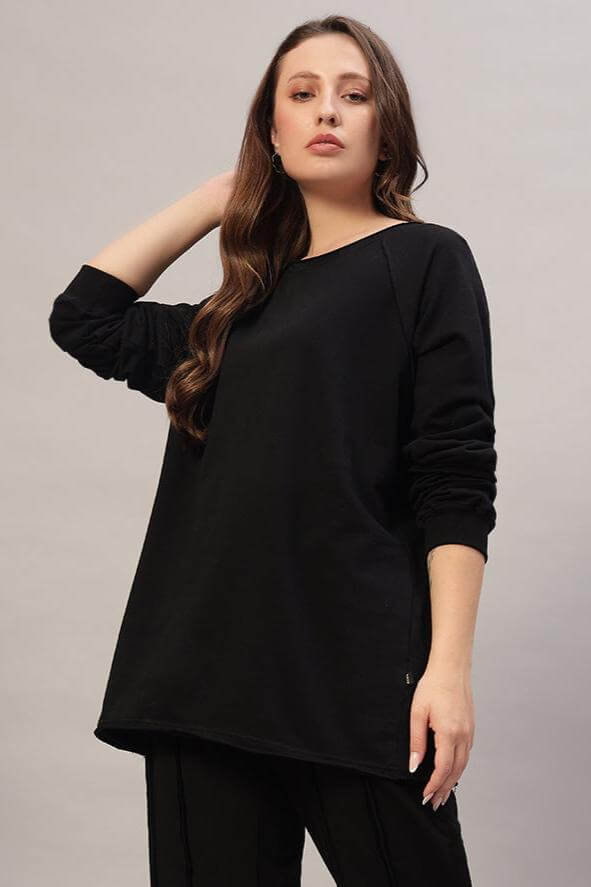 Model wearing WOMEN LAMINA OVERSIZED SWEATSHIRT BLACK, showcasing its chic oversized style in premium ultra-soft fleece.