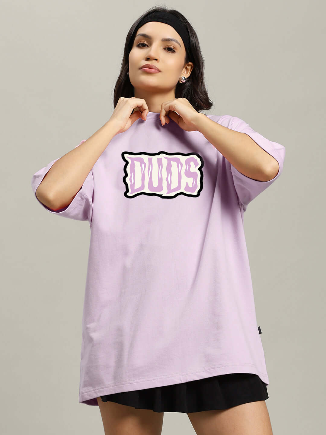 Model wearing oversized lavender t-shirt with 'Let's Get Spooky' print in graffiti style, made of premium cotton blend fabric.
