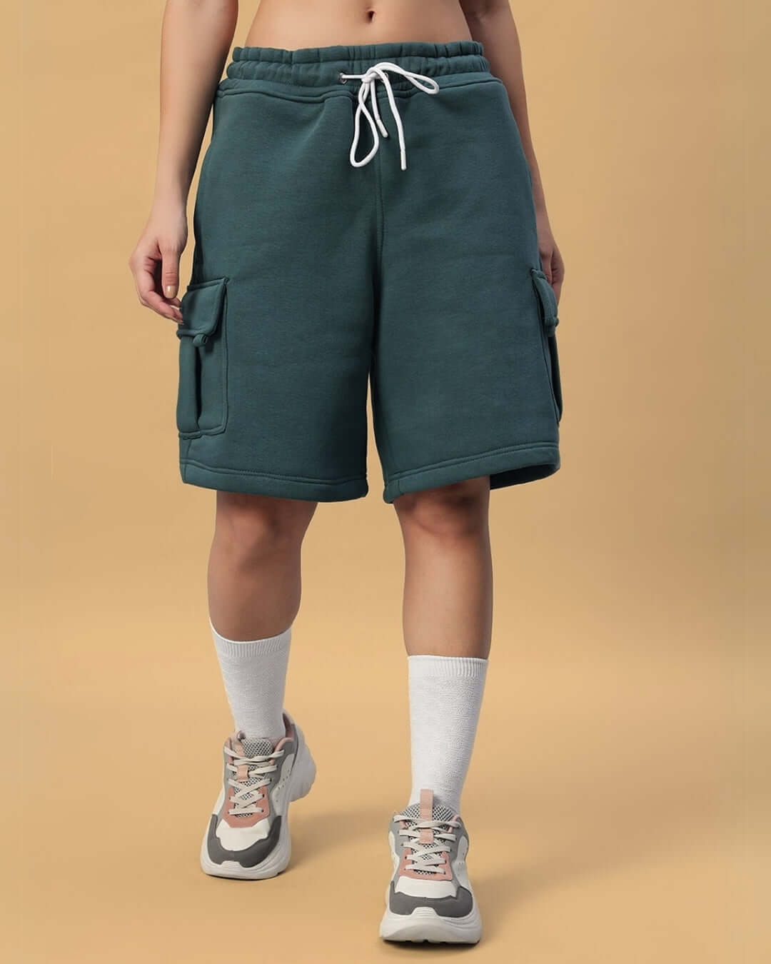 Model wearing WOMEN'S LEOPARD SHARK FLEECE CO-ORD TEAL GREEN shorts, showing front view with pockets and drawstring.