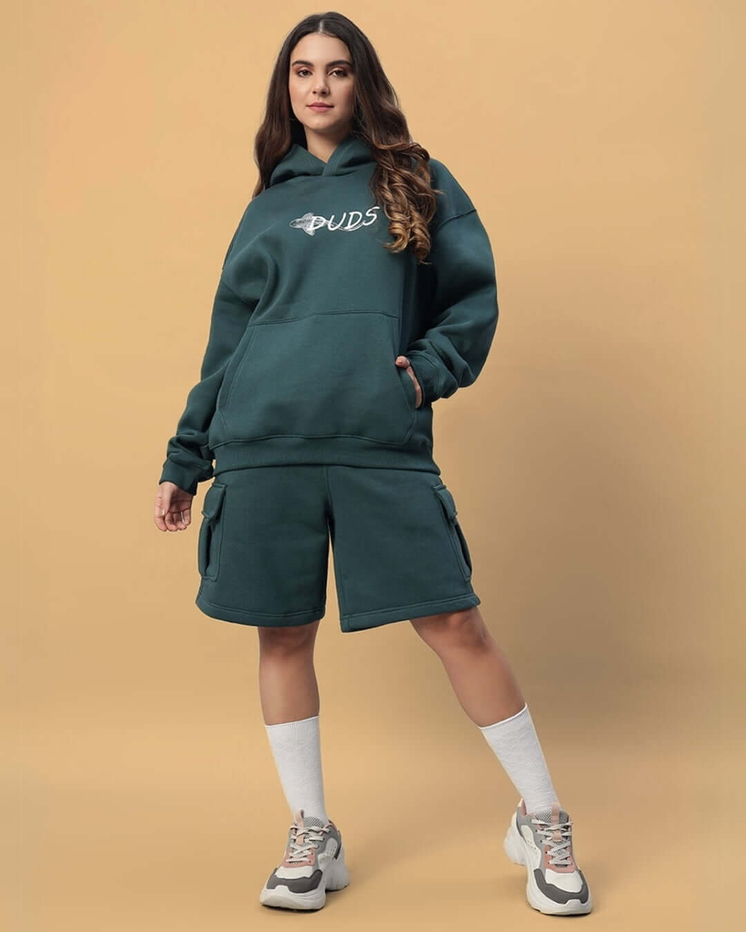 Model wearing WOMEN'S LEOPARD SHARK FLEECE CO-ORD TEAL GREEN from DUDS, showcasing hoodie and shorts set.