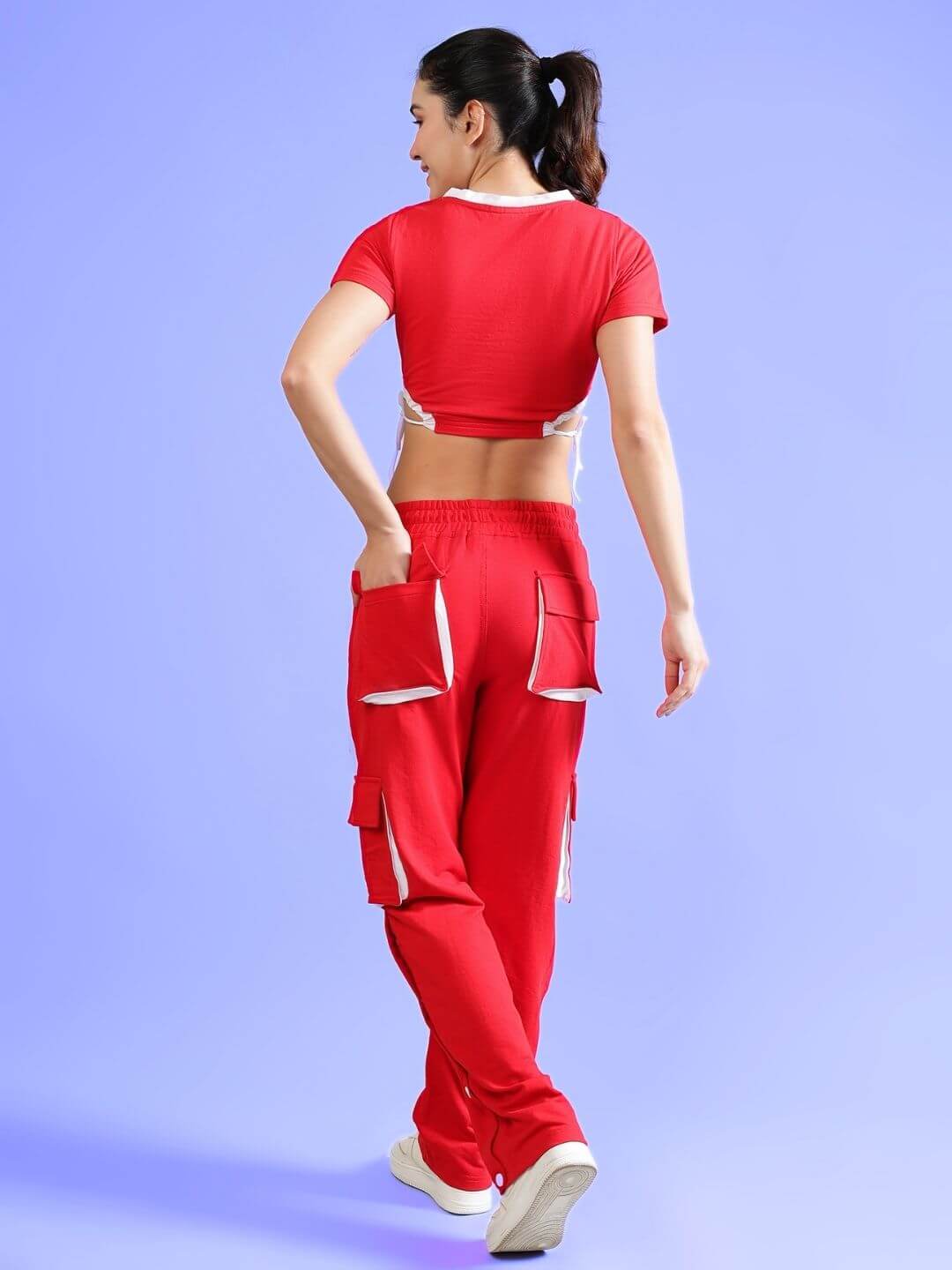 Woman wearing WOMEN'S LERISA ACTIVE CO-ORD SET RED from WEAR DUDS, showcasing the trendy and sporty red outfit with a side view focus.