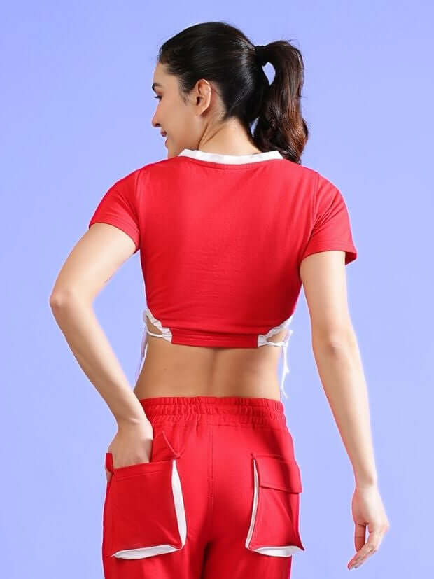 Back view of a woman wearing a red fitted crop top and matching pants, showcasing the stylish design. Made from premium cotton and elastane blend.