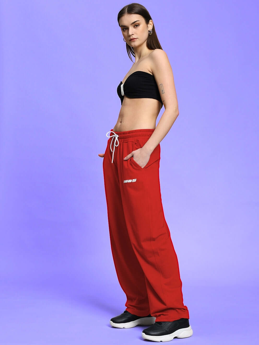 Woman wearing WOMEN'S LIA CO-ORD SET BLACK RED against purple background