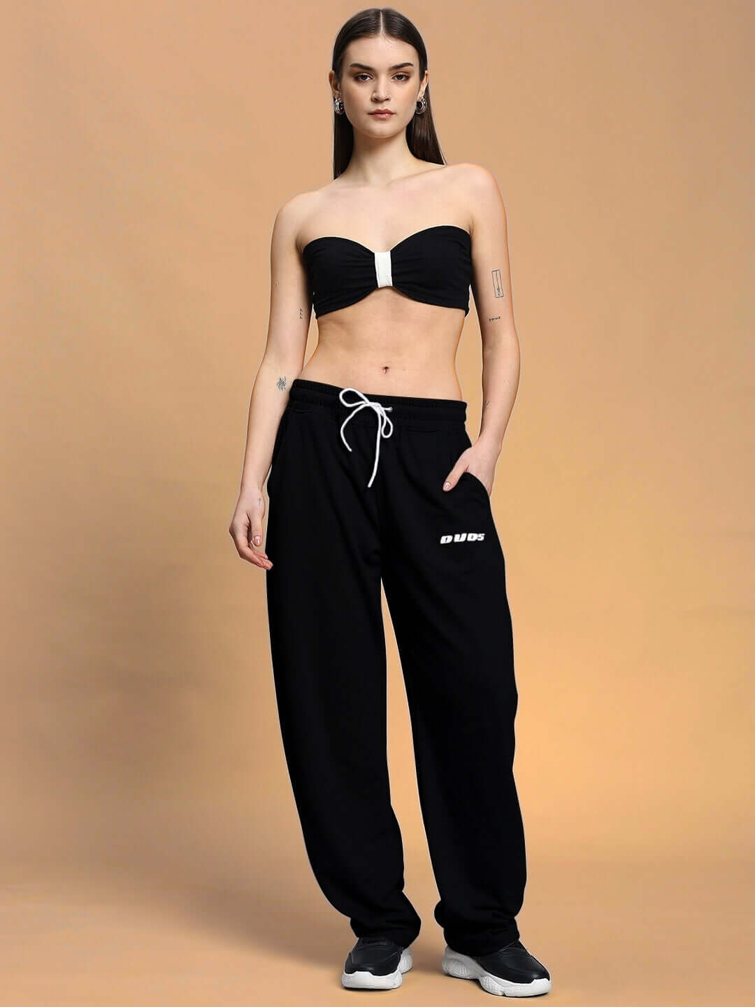 Model wearing Women's LIA Co-ord Set in Black, featuring a bandeau top and relaxed fit joggers with elasticated waistband, by DUBG.