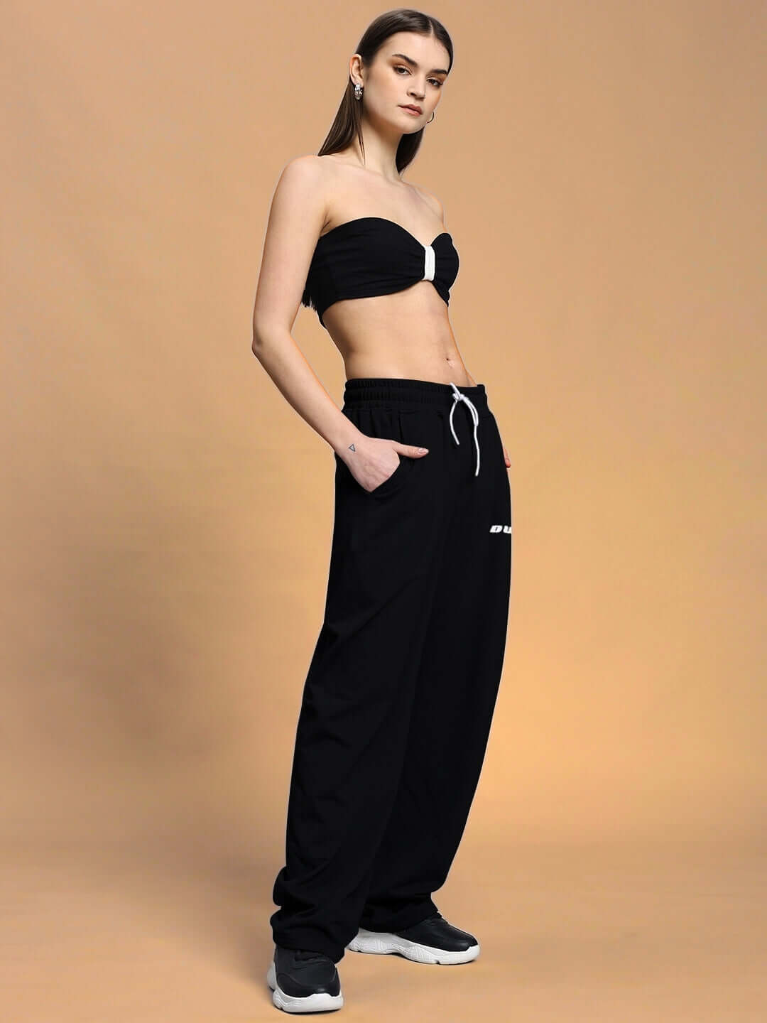 Model wearing Women's Lia Co-ord Set in black with relaxed fit joggers and elasticated waistband, showcasing chic and comfortable style.